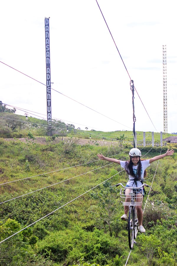 Person riding Sky Bike in Danasan Ecoadventure Park affordable house and lot