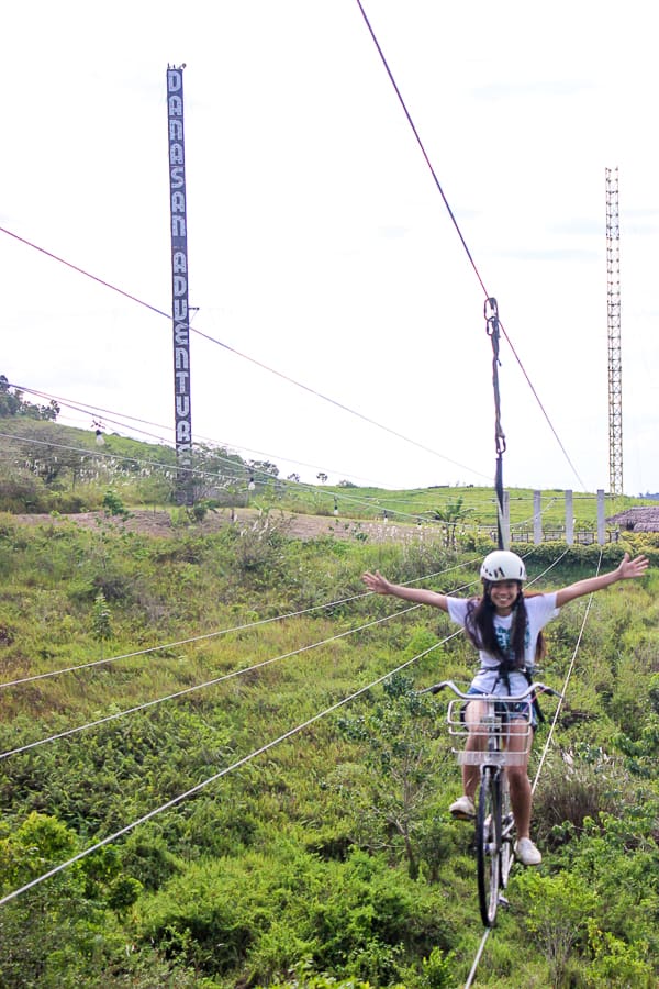 Person riding Sky Bike in Danasan Ecoadventure Park affordable house and lot