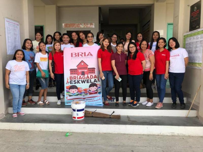 Affordable house and lot A group of people with a BRIAGADA ESKWELA poster
