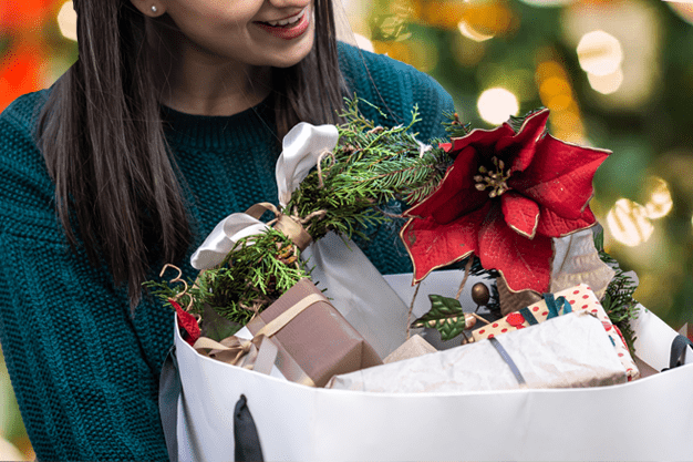 Woman Holding Christmas Decor Shopping Bag