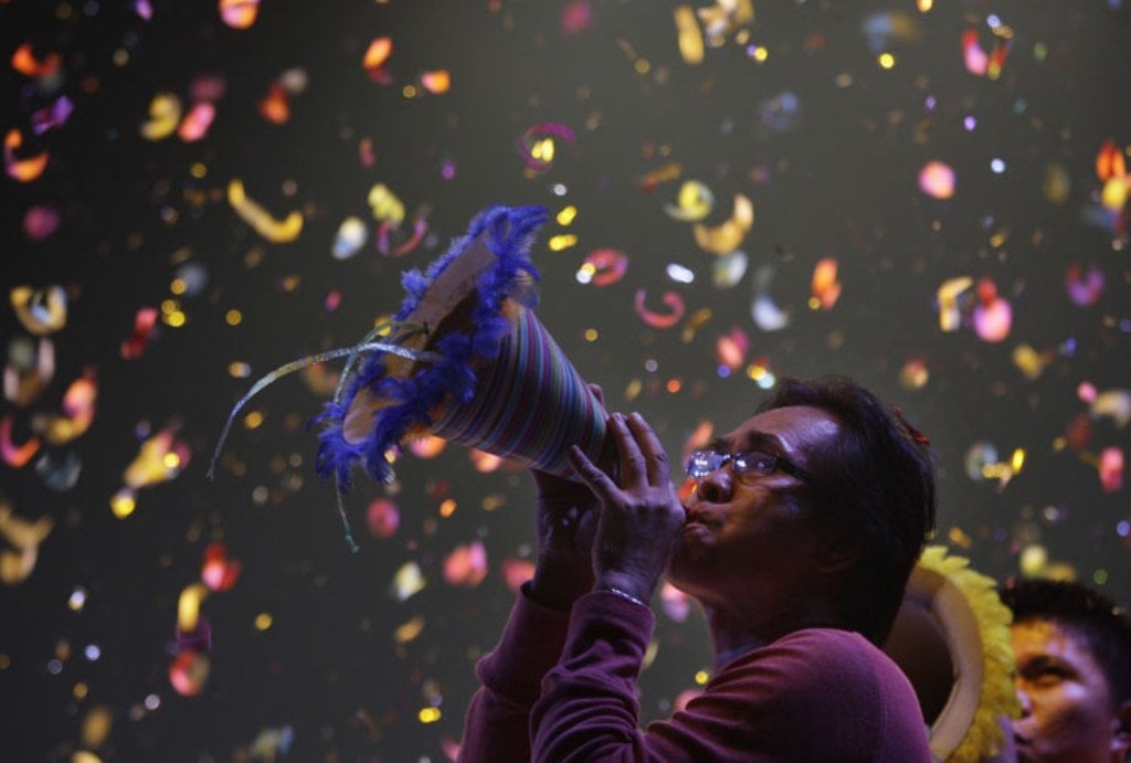 Filipino _blows his paper horn in Manila, Philippines